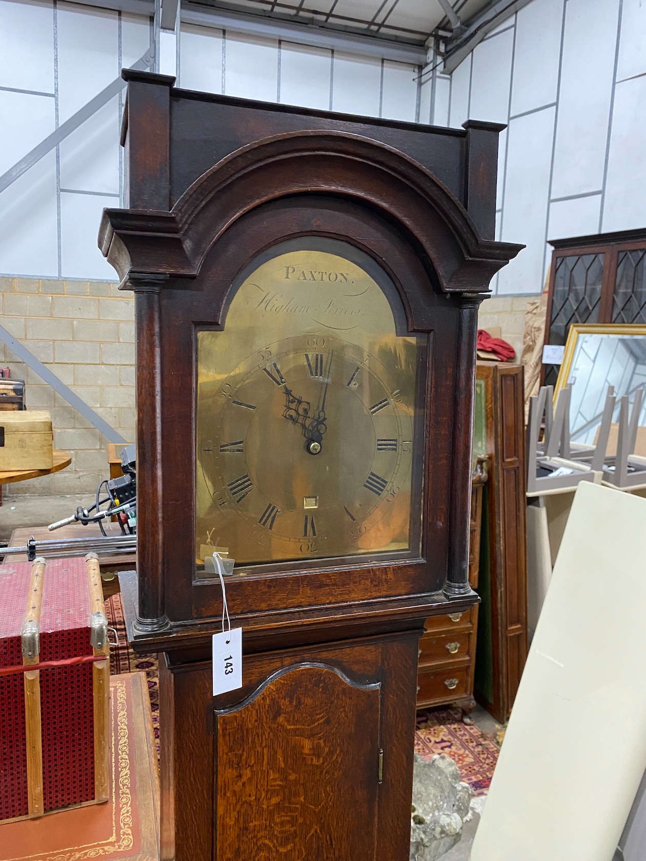 An early 19th century oak 30 hour longcase clock, the arched brass dial marked Paxton, Higham Ferrers, height 199cm